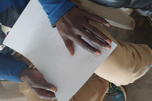 A man reads a Braille document.