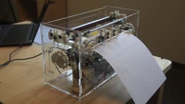 A BrailleRAP with a transparent frame placed on a table.