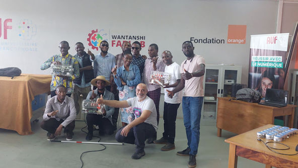 Attendee in the Lubumbashi workshops celebrating the creation of 2 BrailleRAPs.