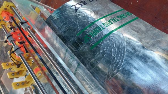 A BrailleRAP that embosses a sea turtle drawing on metal sheet.