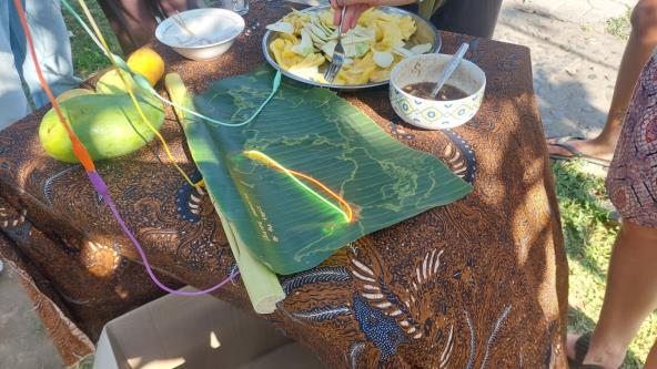 A world map embossed on a banana leaf.