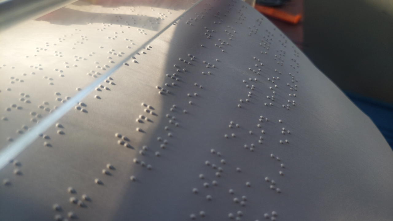 The fixed BrailleRAP embossing a Braille text